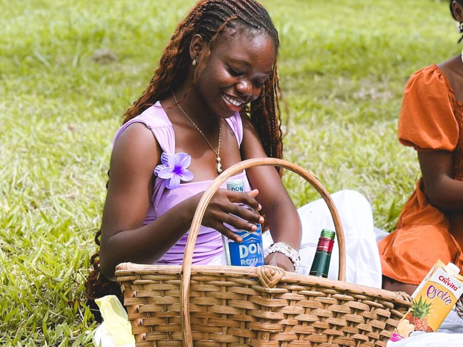 A child smiling over a picnic basket on the grass